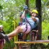 Man zip lining in costa rica during the rainy season