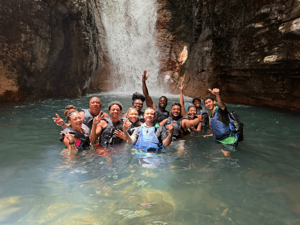 People swimming in front of la leona waterfall